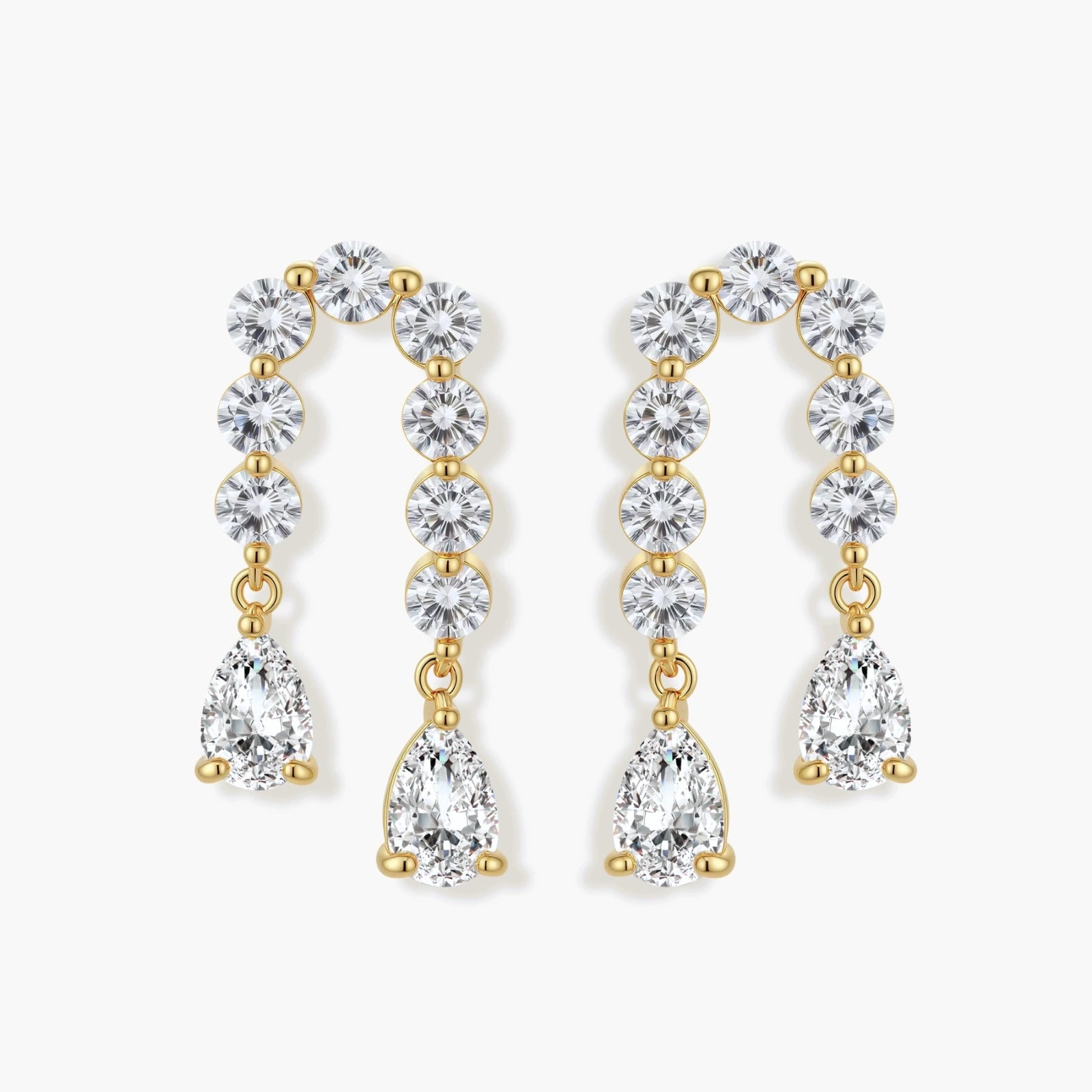 Gold-plated earrings with vertical line of clear crystals and teardrop pendants on neutral background