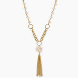 Long gold-plated necklace with freshwater pearls, chunky chain links, and flowing tassel pendant