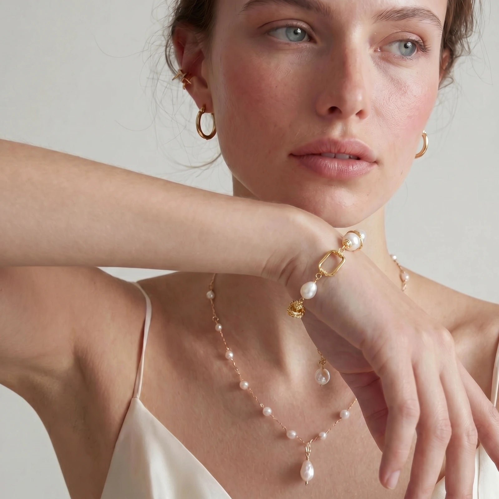 14K gold plated bracelet with freshwater pearls, filigree details, and mixed geometric elements on white background.