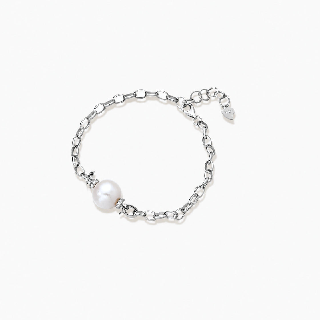 Rhodium-plated silver chain bracelet with single white freshwater pearl and heart charm clasp on cream background