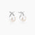 Rhodium-plated silver stud earrings with sparkling X design above lustrous round freshwater pearls on white background.