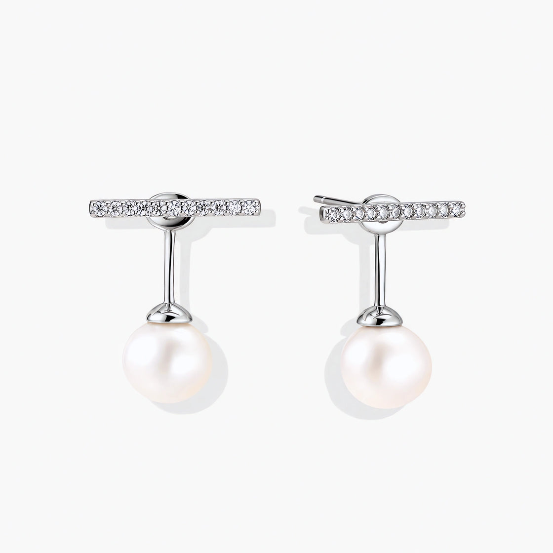 Rhodium-plated sterling silver ear jacket earrings with diamond-set horizontal bar and freshwater pearl drop