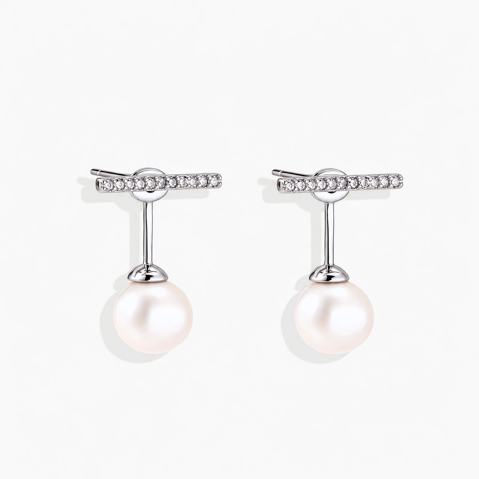 Rhodium-plated sterling silver ear jacket earrings with diamond-set horizontal bar and freshwater pearl drop