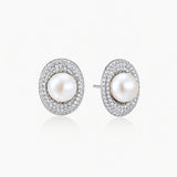 Elegant stud earrings with cream freshwater pearls surrounded by sparkly pavé crystals on rhodium-plated silver setting