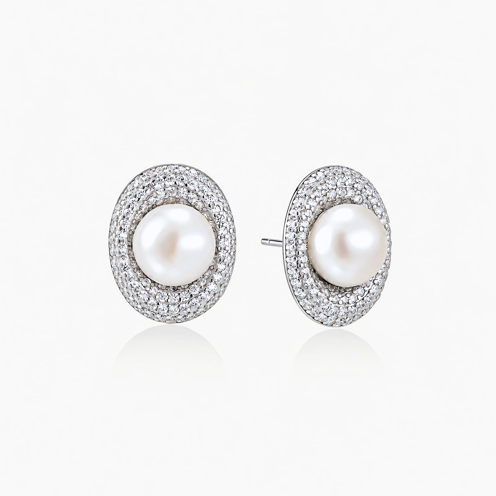 Elegant stud earrings with cream freshwater pearls surrounded by sparkly pavé crystals on rhodium-plated silver setting