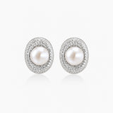 Elegant stud earrings with cream freshwater pearls surrounded by sparkly pavé crystals on rhodium-plated silver setting