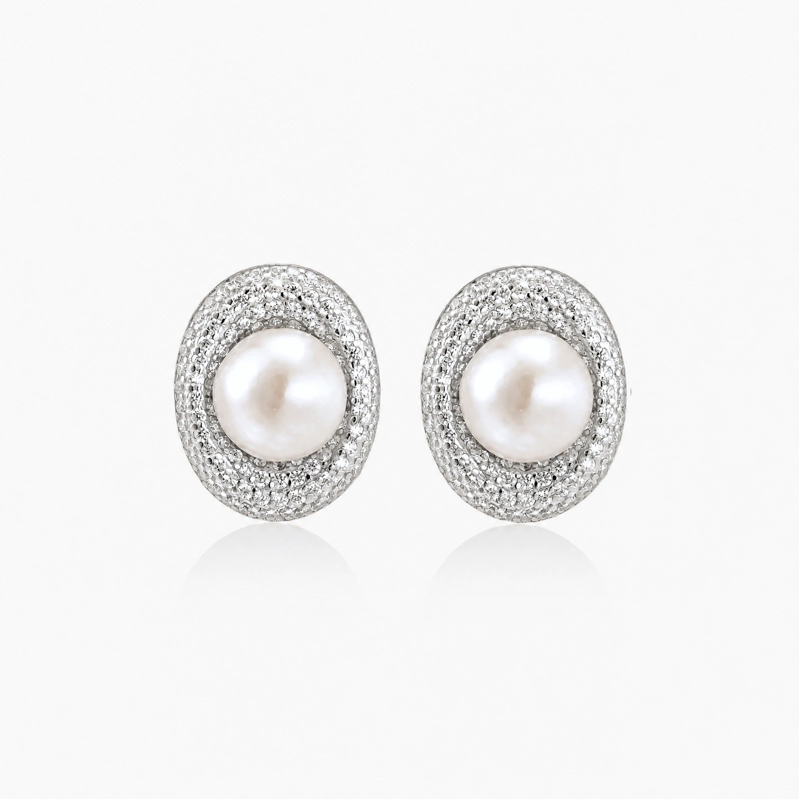 Elegant stud earrings with cream freshwater pearls surrounded by sparkly pavé crystals on rhodium-plated silver setting