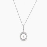 Oval sterling silver pendant with crystal halo surrounding a white freshwater pearl on delicate chain