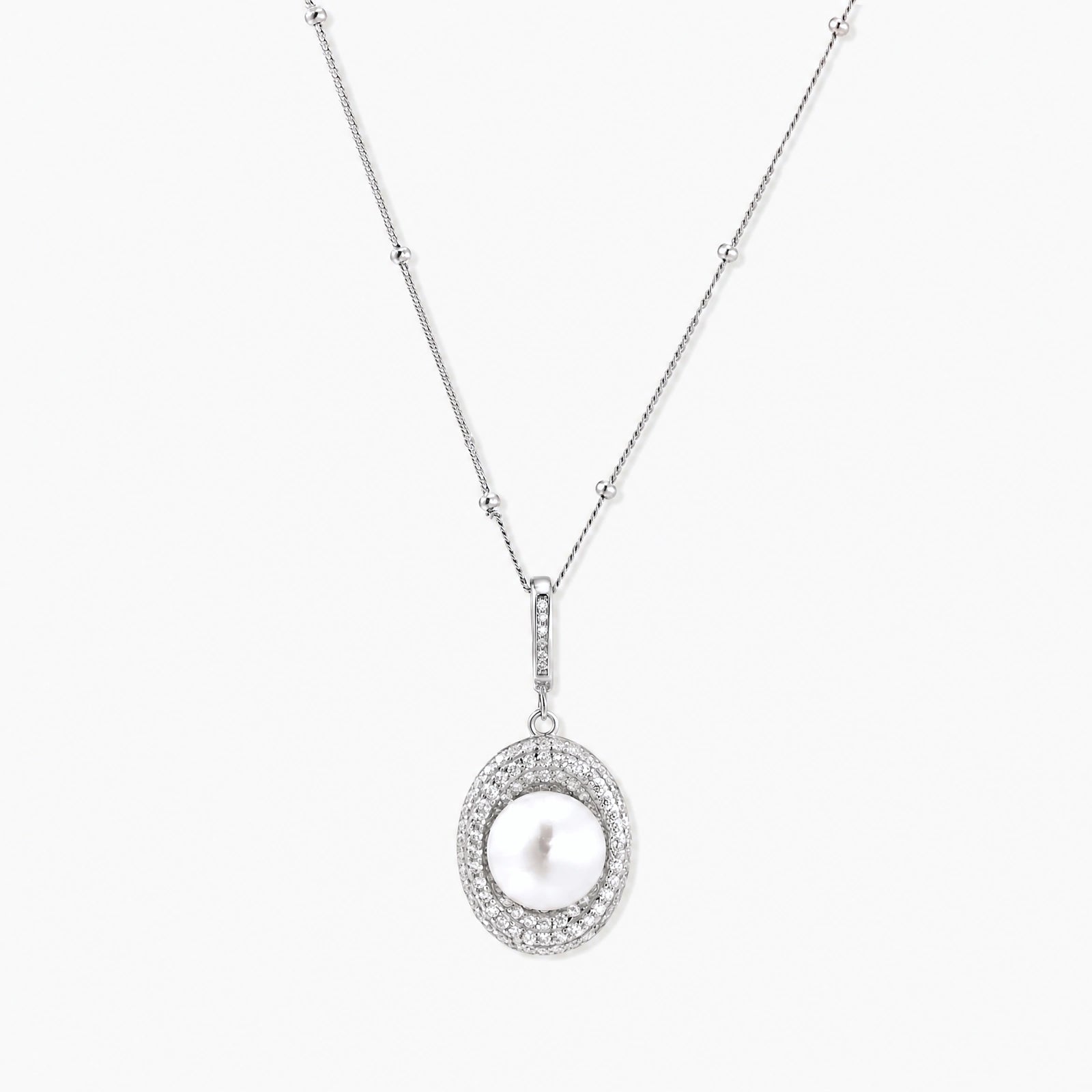 Oval sterling silver pendant with crystal halo surrounding a white freshwater pearl on delicate chain
