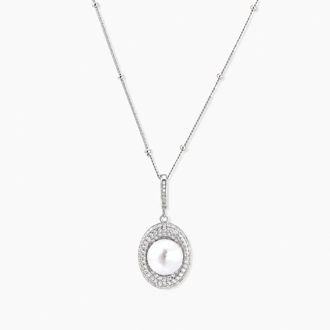Oval sterling silver pendant with crystal halo surrounding a white freshwater pearl on delicate chain