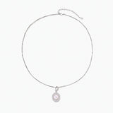 Oval sterling silver pendant with crystal halo surrounding a white freshwater pearl on delicate chain