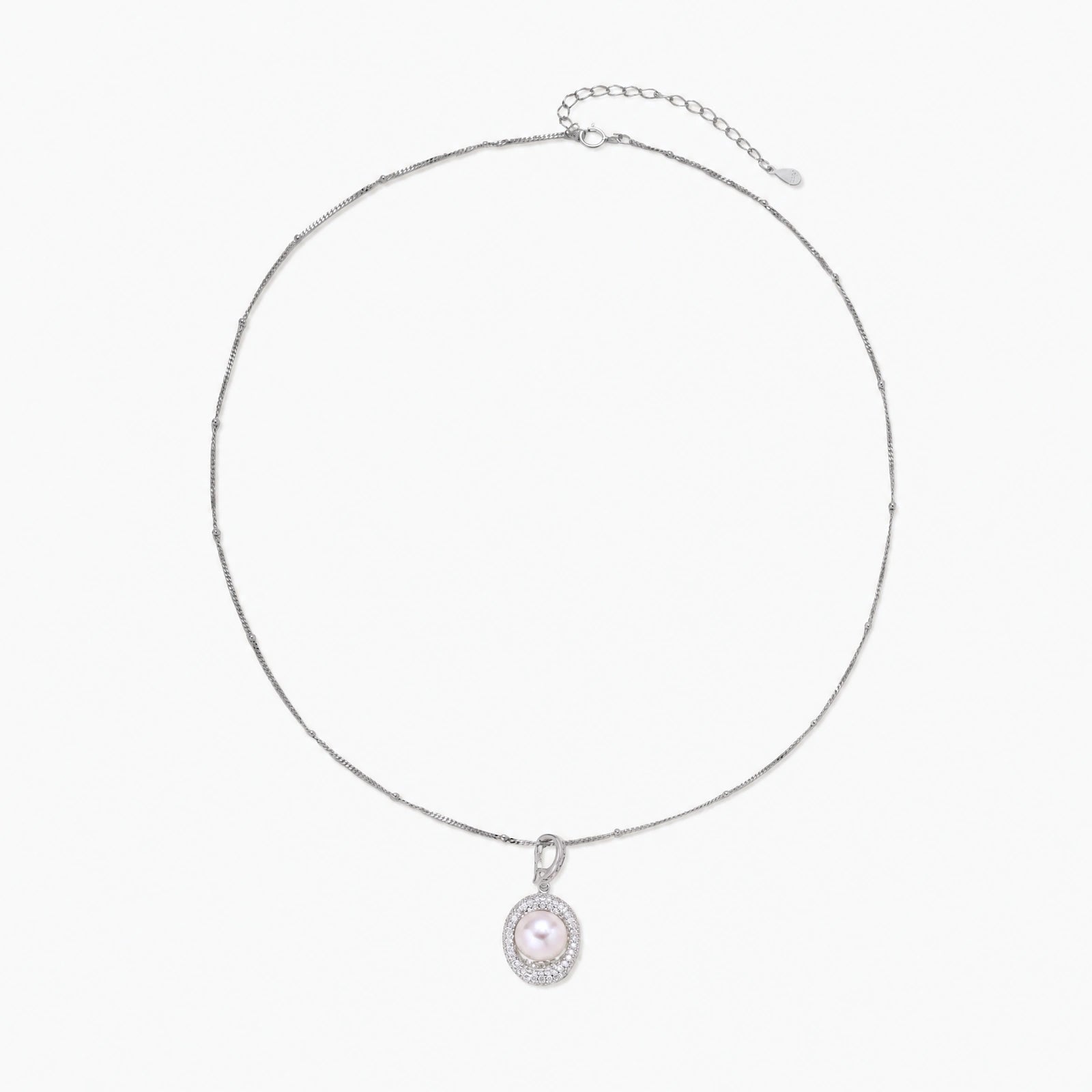 Oval sterling silver pendant with crystal halo surrounding a white freshwater pearl on delicate chain