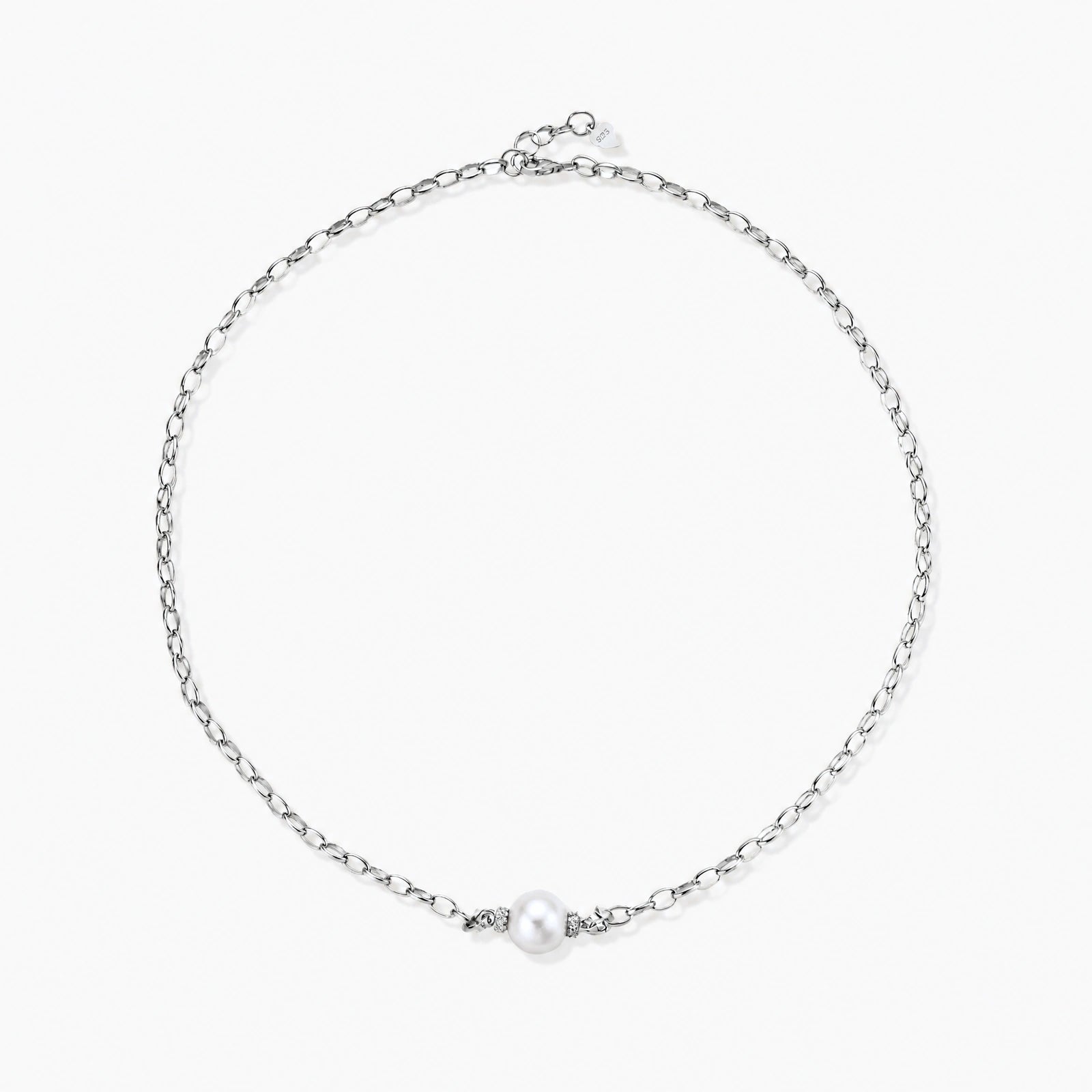 Dainty rhodium-plated silver chain necklace with centered 10mm freshwater pearl and crystal accents on cream background