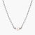 Dainty rhodium-plated silver chain necklace with centered 10mm freshwater pearl and crystal accents on cream background