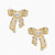 Gold-plated bow earrings with openwork design, marquise center stones, and flowing ribbon tails adorned with zirconia crystals.