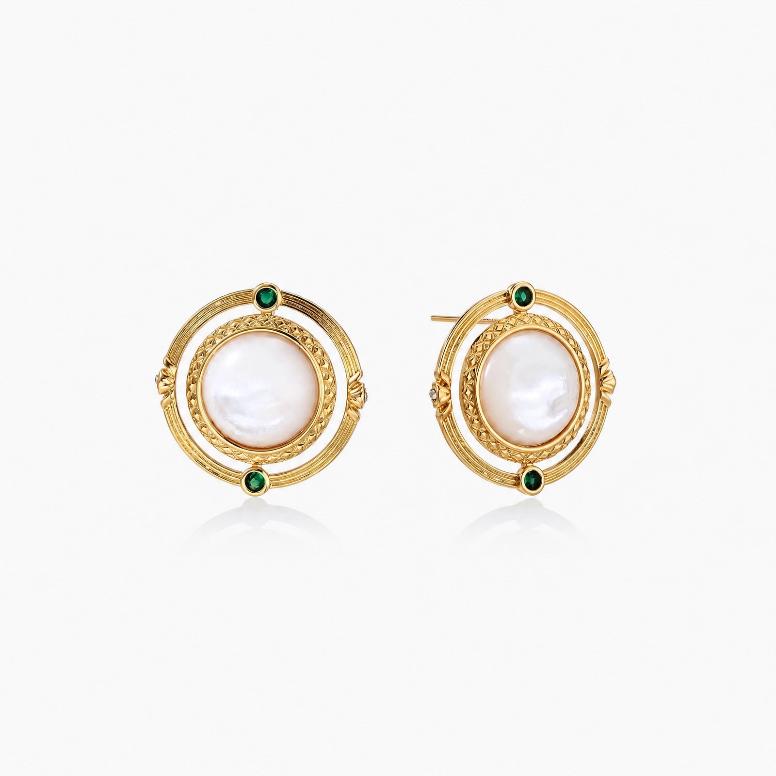 Circular gold stud earrings with iridescent mother-of-pearl center and green zirconia accents on cream background.