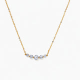Delicate 14K gold-plated necklace with five graduated zirconia stones arranged in a curved arc on fine chain