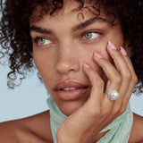 Rhodium-plated silver ring with round pearl center, double halo of baguette and round crystals forming cushion shape