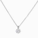 Platinum-plated sterling silver necklace with round clear crystal pendant and decorative bail on neutral background.