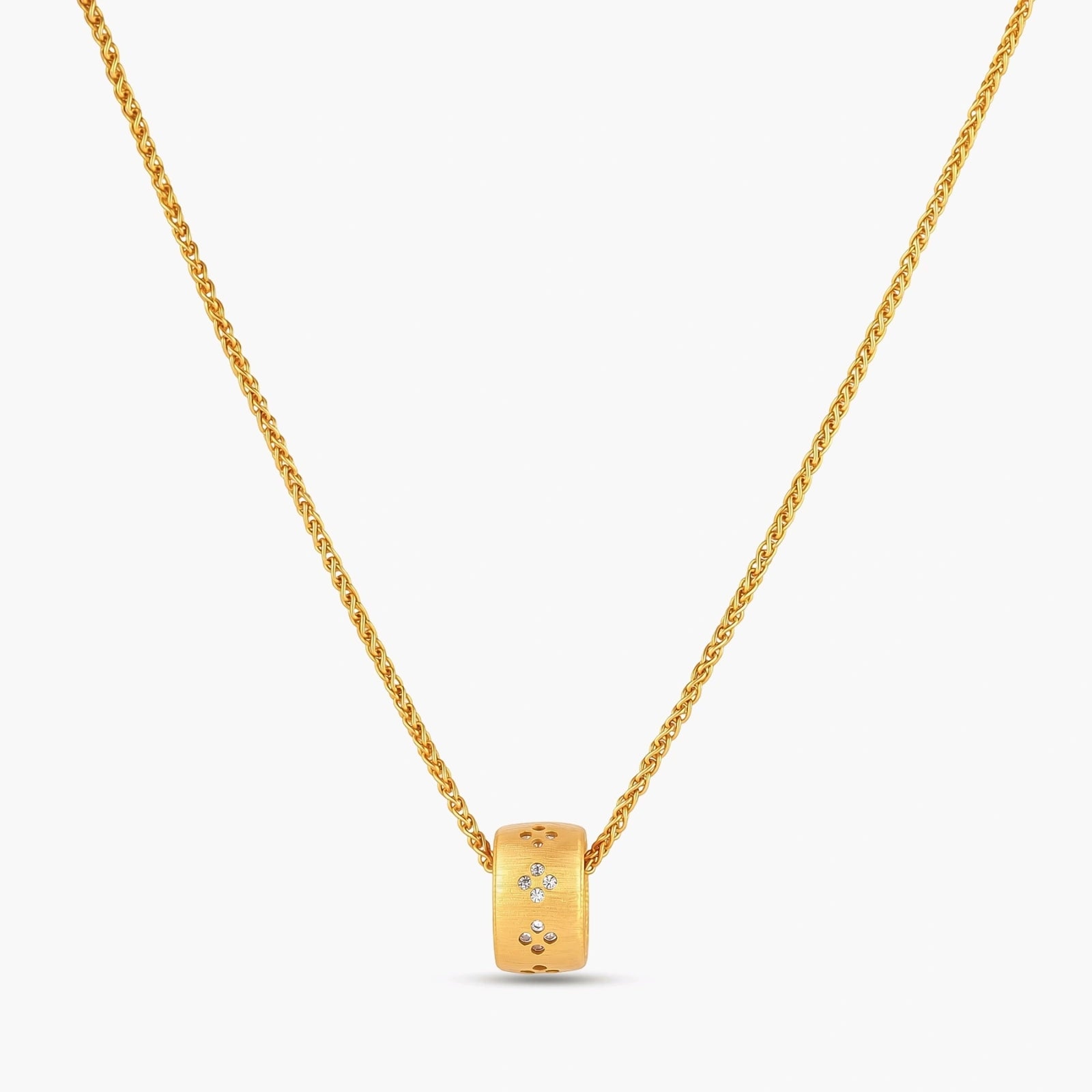 Gold-plated cylindrical ring pendant with brushed finish and scattered crystal accents on a wheat-link chain, cream background.
