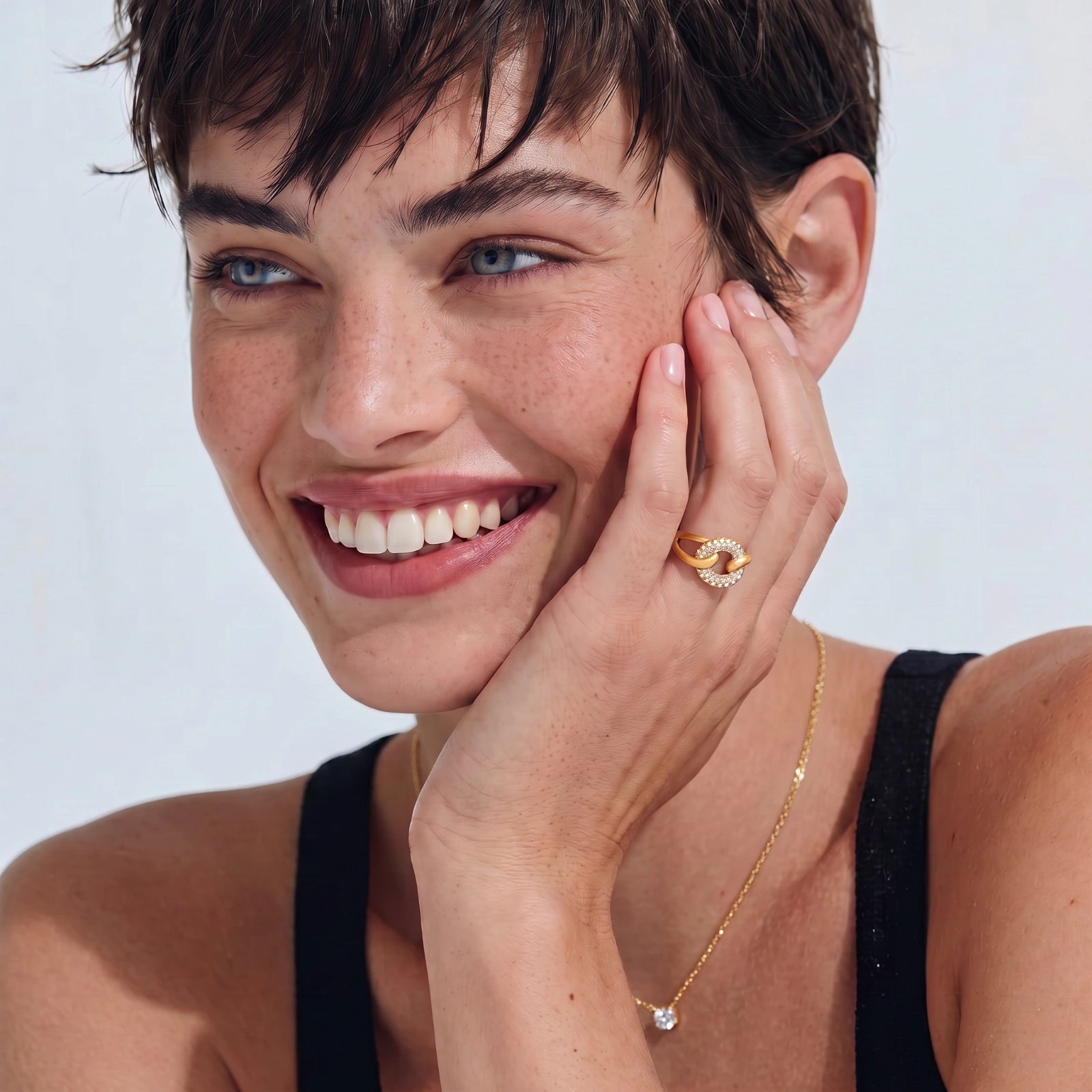 Adjustable 18K gold-plated open cuff ring with interlocking chain links, one brushed gold, one pavé-set cubic zirconia. S925 stamped.