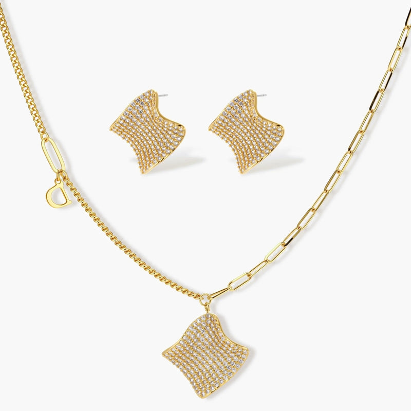 Gold-plated wavy jewelry set with crystal detailing featuring necklace with dual chains and matching textured earrings