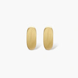 Small gold huggie earrings with matte finish, 14mm diameter, shown against cream background for everyday elegance.