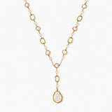 Long gold-plated necklace with alternating freshwater pearls and crystal bezels, featuring a large baroque pearl pendant