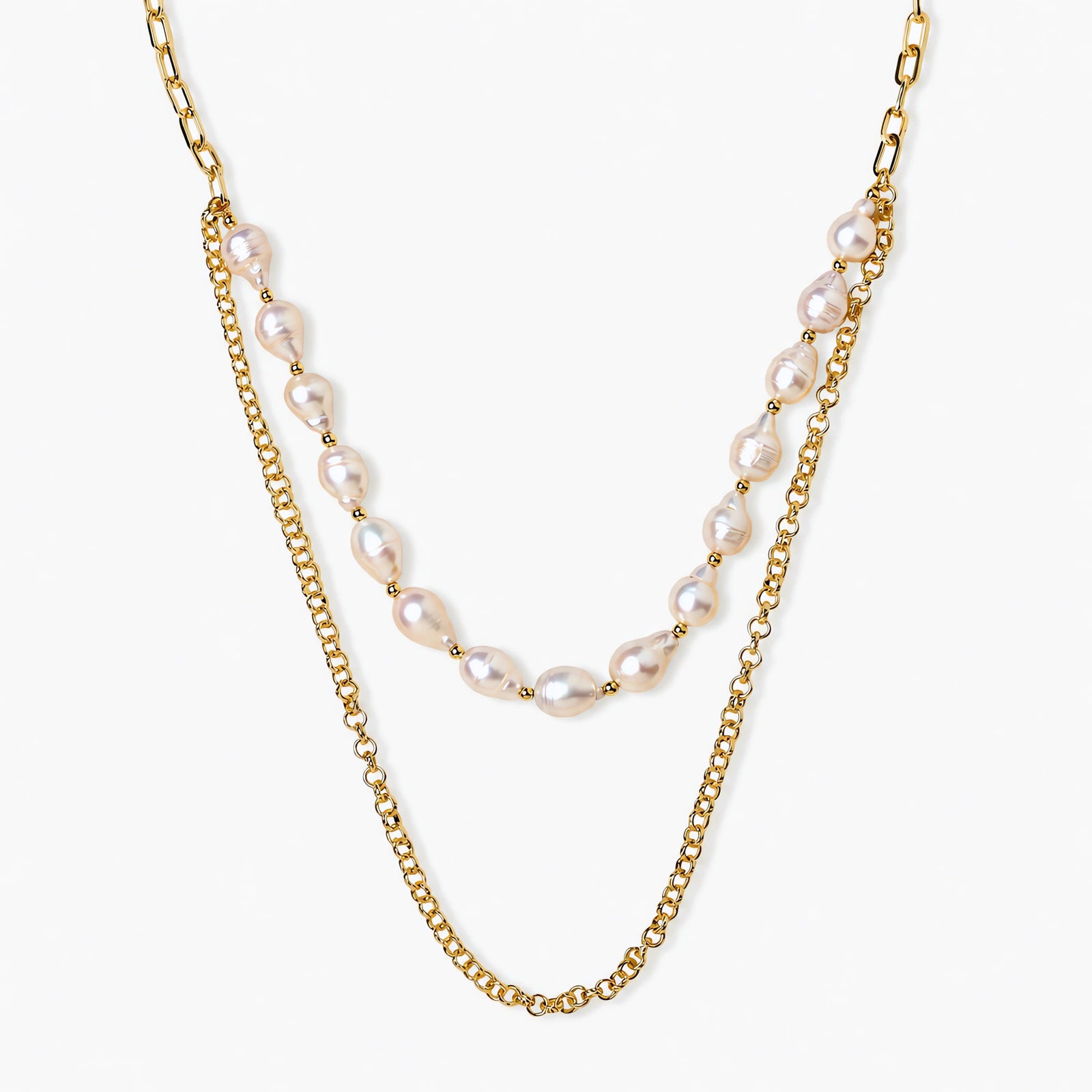 Layered gold chain necklace with organic baroque freshwater pearls and adjustable length on cream background