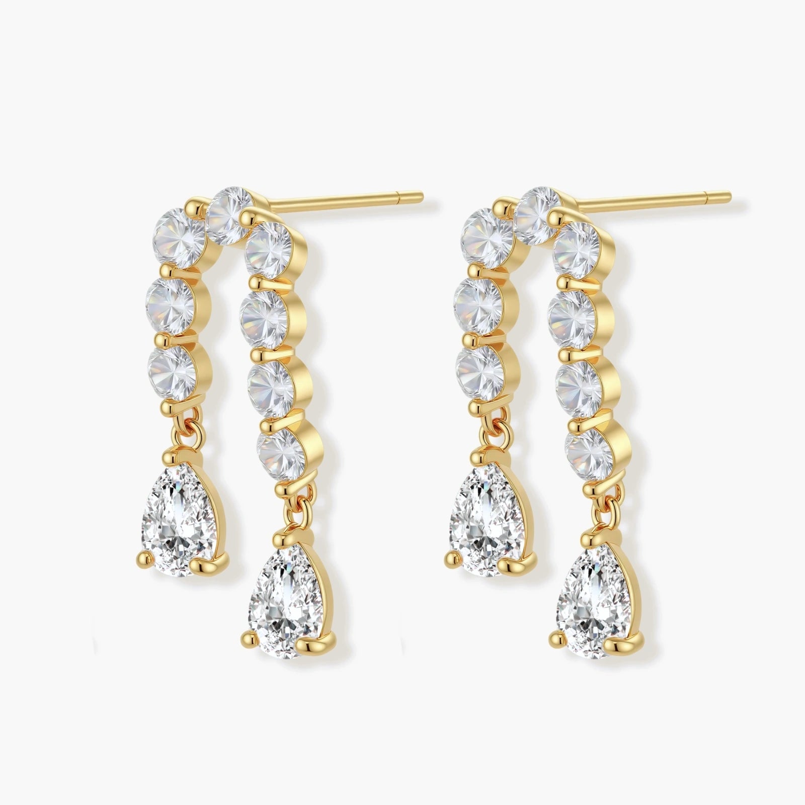 Gold-plated earrings with vertical line of clear crystals and teardrop pendants on neutral background