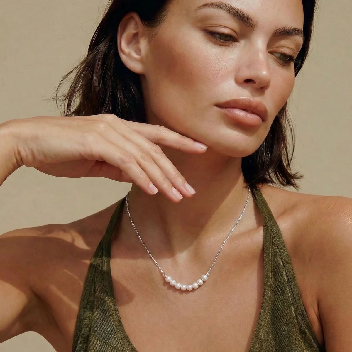 Woman wearing a sterling silver necklace with a row of freshwater pearls