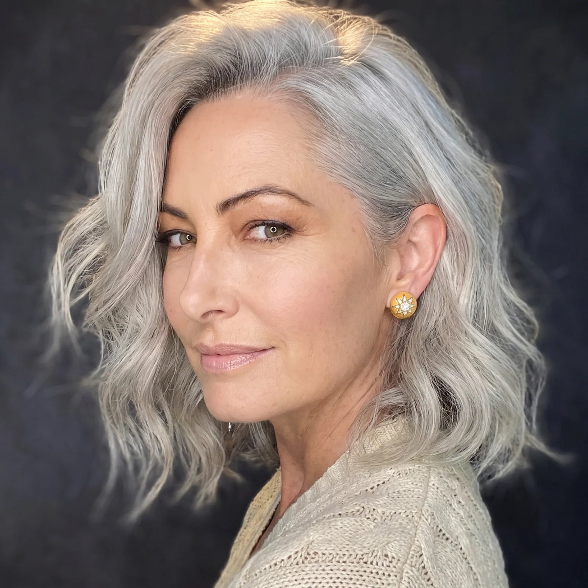 Woman with silver hair wearing gold Celestial Dome stud earrings